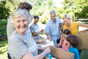 Happy volunteer family separating donations stuffs on a sunny day-1